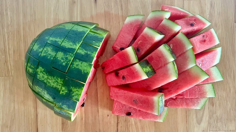Watermelon sticks half together and half fallen on wooden table