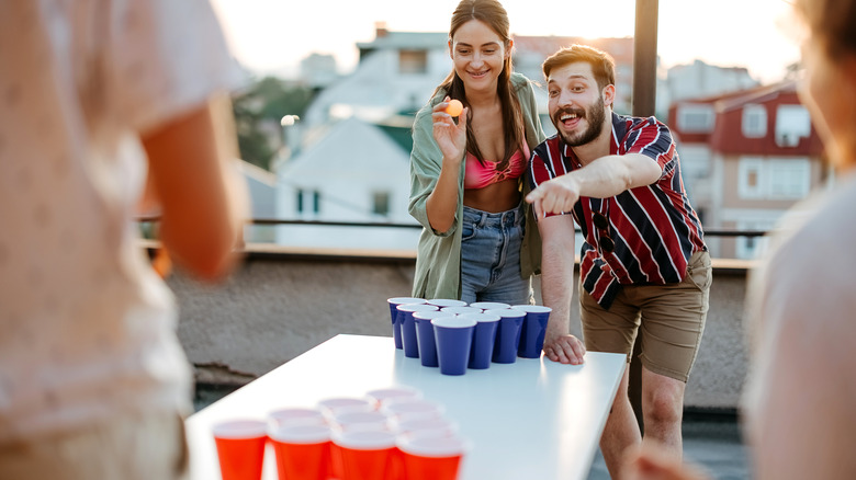 Couple playing beer pong