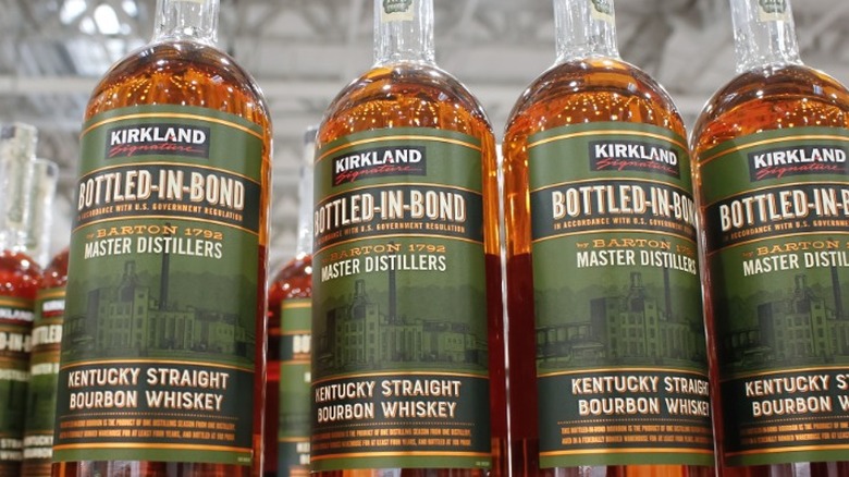 Bottles of Kirkland bottled-in-bond bourbons on a shelf.