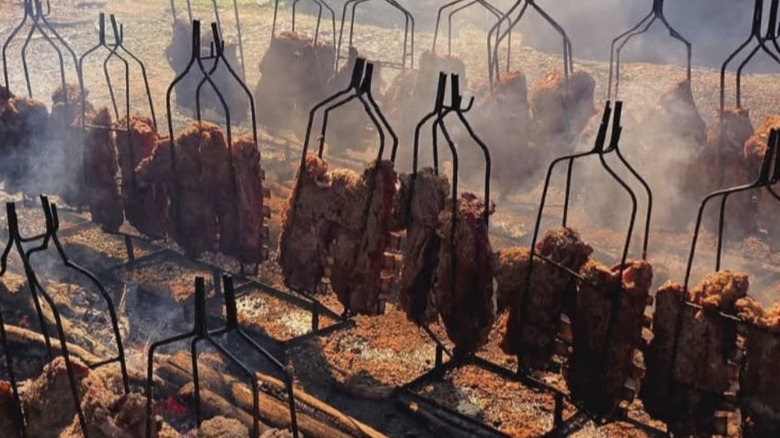 Costela ribs cooking on racks over fire