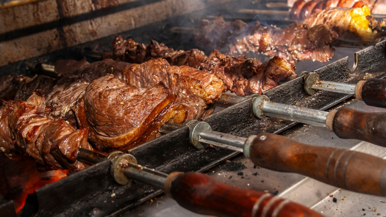 Meat cooking on skewers in Brazilian steakhouse