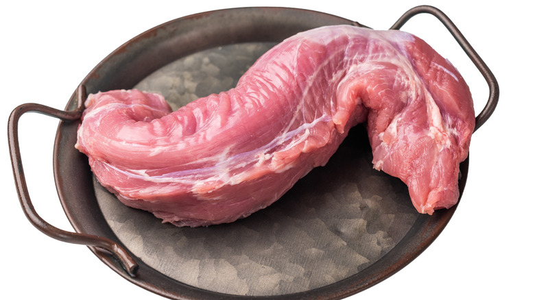 Uncooked pork loin in a pan