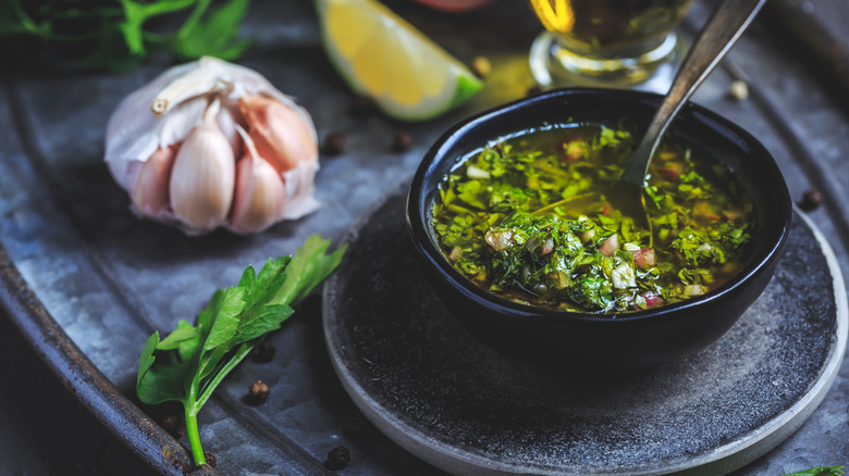 Fresh, green chimichurri in a black bowl