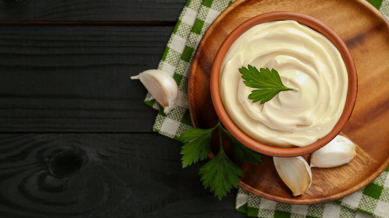 A bowl of molho de alho in a rustic bowl