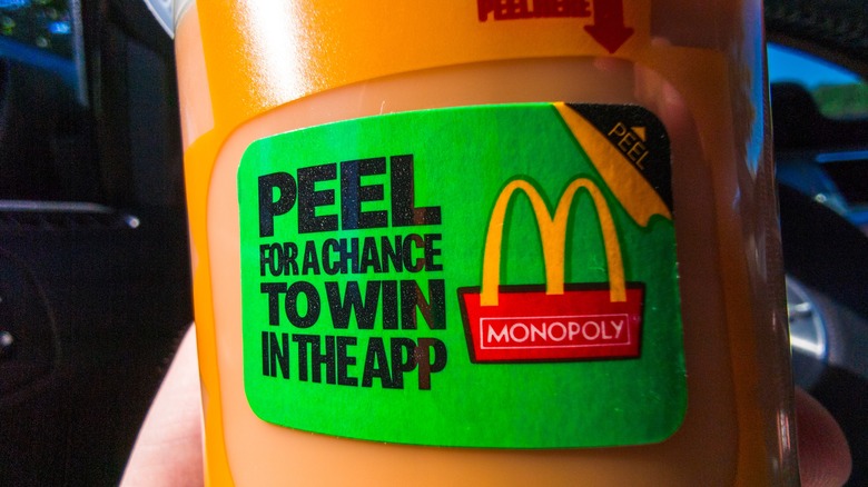 a McDonald's Monopoly game piece on a cup