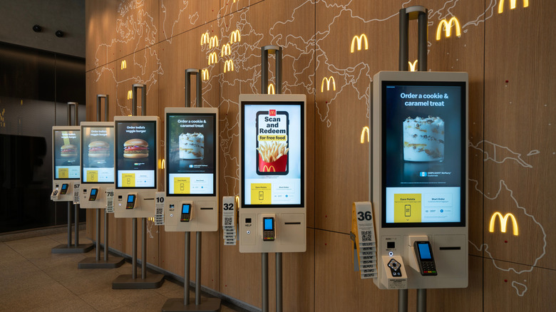 Self-service kiosks and a McDonald's world locations map inside the McDonald's Global Headquarters Restaurant within its corporate headquarters in Chicago, Illinois