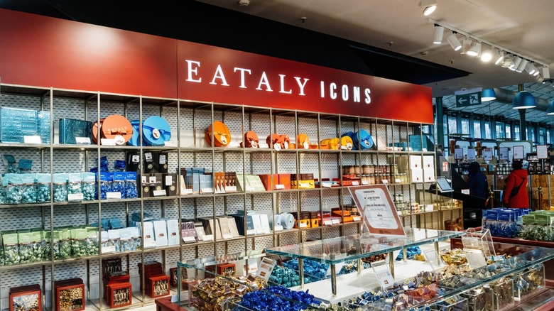 Interior of an Eataly store featuring a colorful chocolate and confectionery display labeled Eataly Icons, with neatly arranged premium sweets and gift boxes