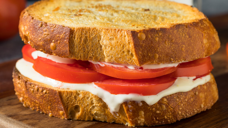 A tomato and mayo sandwich on thick crusty bread