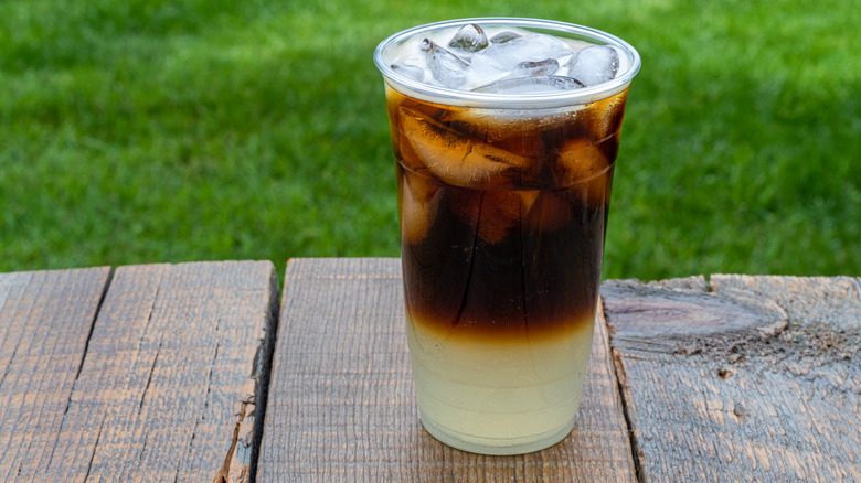 Iced cold brew lemonade on a wooden table outdoors