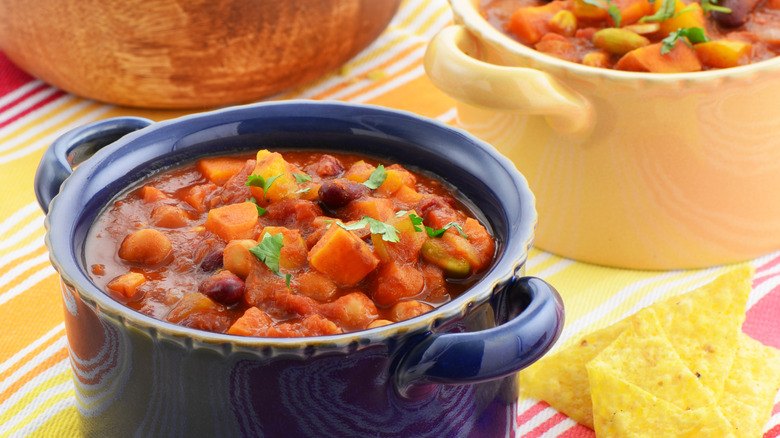 Vegetarian sweet potato chili with beans in a blue bowl