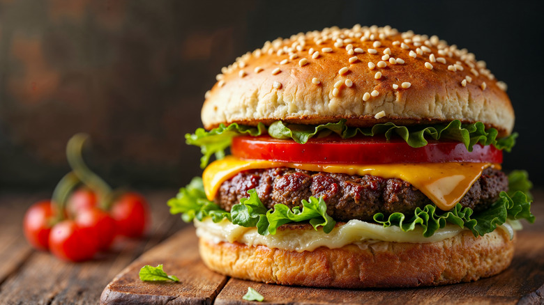 A perfectly crafted burger on a wooden plank.