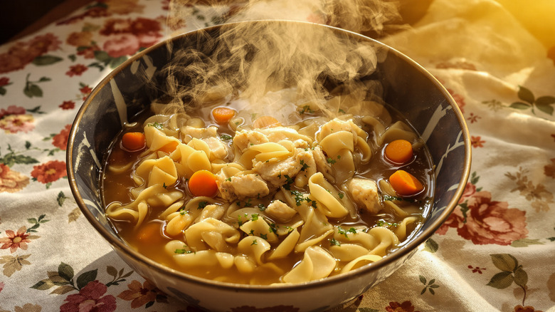 chicken noodle soup steaming on table