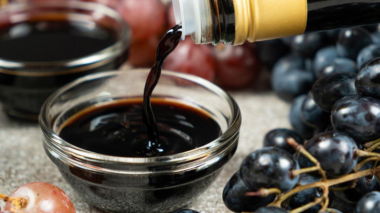 Balsamic vinegar being poured into a small glass bowl