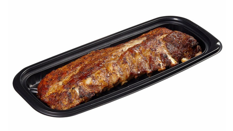 The precooked Kirkland Signature Seasoned St. Louis Ribs from Costco's deli section in a black plastic container
