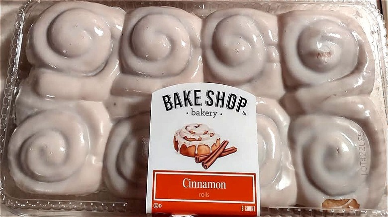 A plastic package of Aldi Bake Shop Cinnamon Sweet Rolls covered in icing