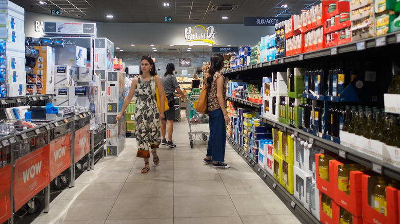 shoppers walk through an Aldi aisle