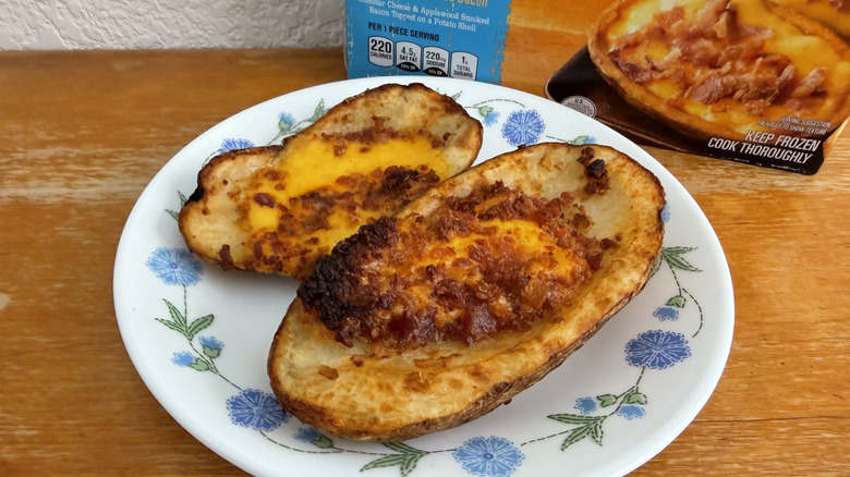 close-up of two Aldi potato skins on a small plate with their box in the background