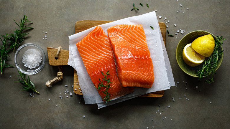 Raw salmon fillets on a wooden board