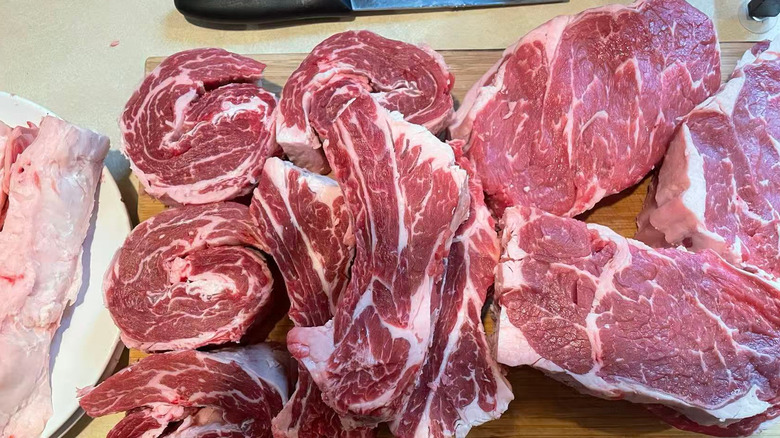 A rib roast from Aldi cut into steaks sitting on a cutting board.