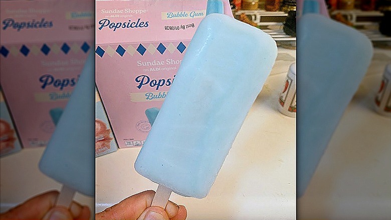 hand holding a Sundae Shoppe Bubble Gum Popsicle in front of the product box