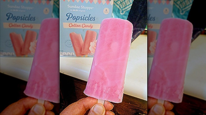 hand holding a Sundae Shoppe Cotton Candy Popsicle in front of the product box