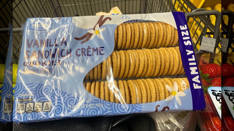 A pack of Benton's Vanilla Sandwich Crème Cookies from Aldi in a shopping cart