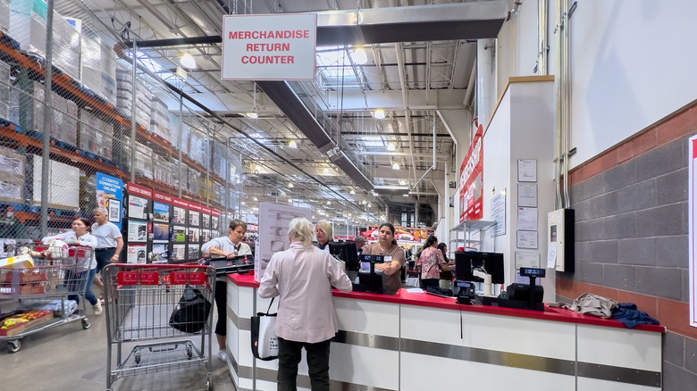 The Costco return counter with staff and employees around.