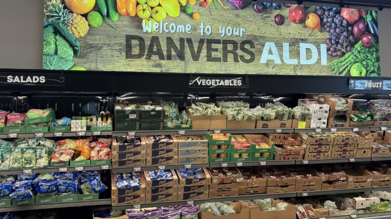 Produce aisle in Aldi store with sign above that says "welcome to your Danvers Aldi"