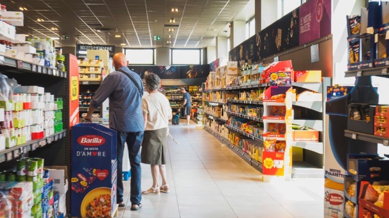 Aisle inside Aldi store with a couple shopping