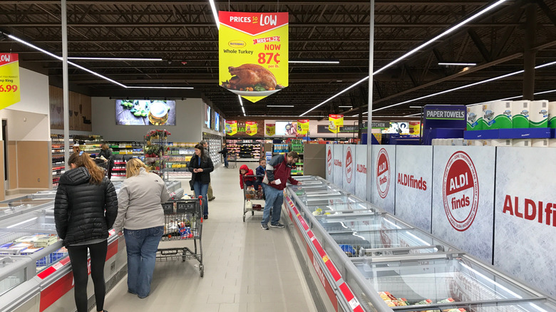 The inside of an Aldi store with turkey on sale in the coolers