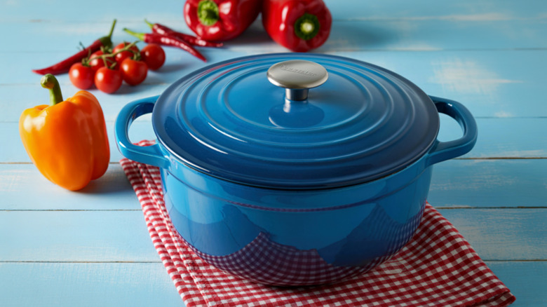 Blue Dutch oven with peppers and tomatoes