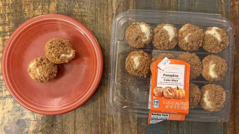 Bake Shop Pumpkin Cake Bites from Aldi in clamshell package next to plate with two cake bites