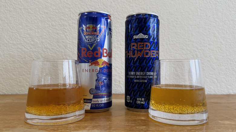 small, half-full glasses of each drink in front of their respective cans