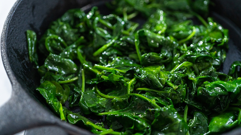 cooked shriveled spinach in pan