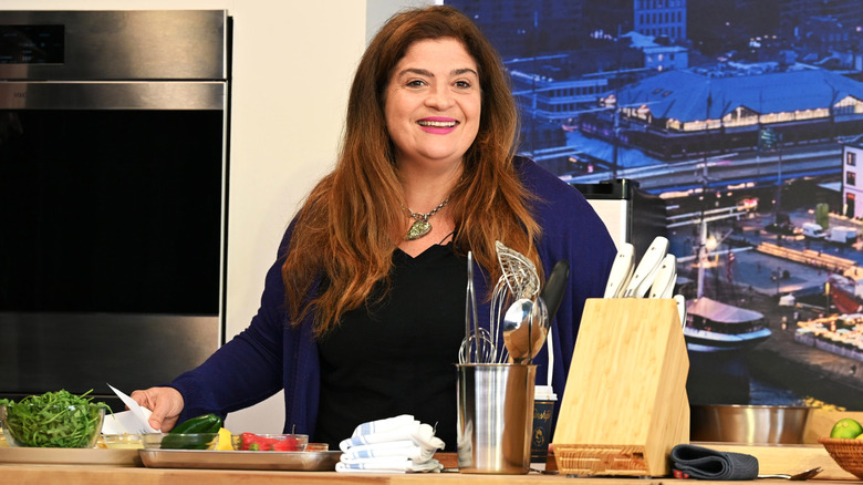 Alex Guarnaschelli wearing pink lipstick and smiling