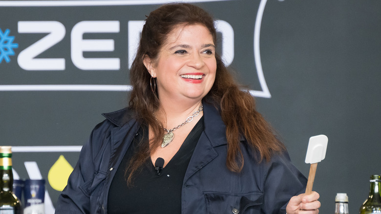 Alex Guarnaschelli holding spatula at cooking demo