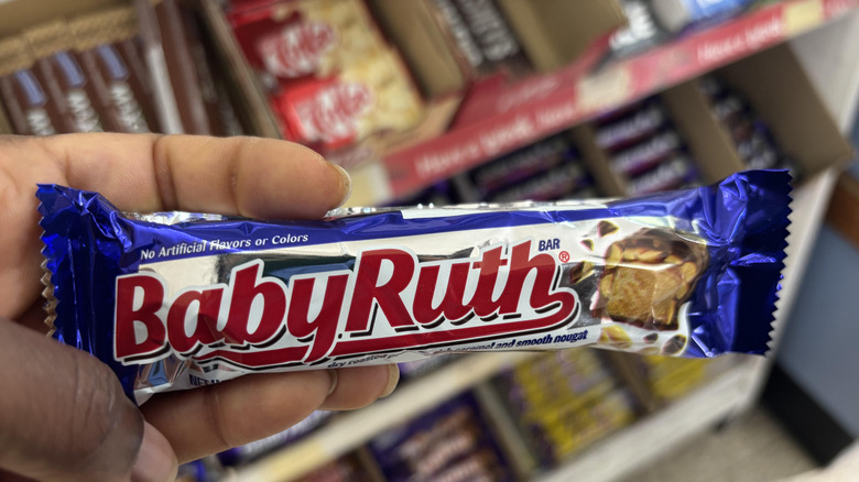 hand holding a Baby Ruth candy bar