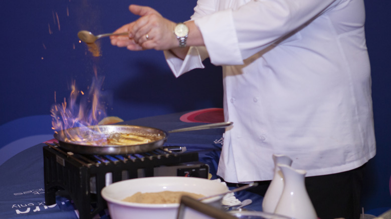chef preparing bananas Foster en flambé﻿
