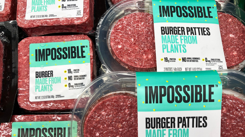 Packages of Impossible plant-based burger patties.