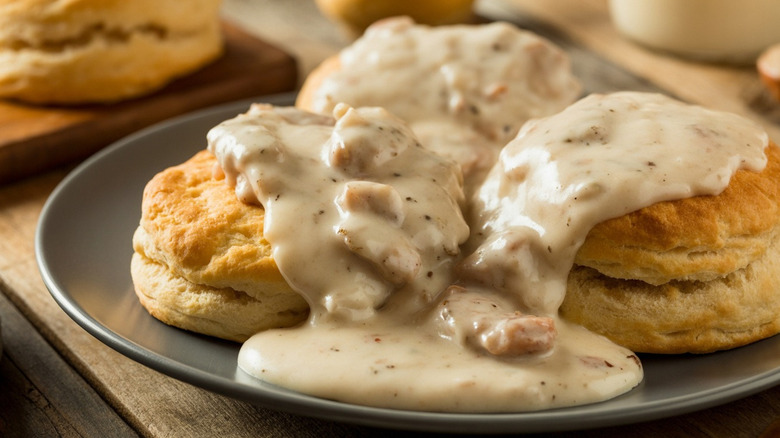 Southern-style biscuits and gravy on a gray plate.