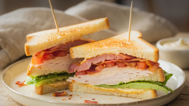 turkey club sandwich on a white plate