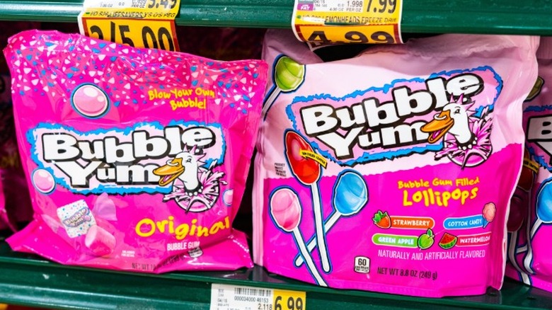 A store shelf stocked with bags of bubblegum in its original form and in bubblegum lollipops.