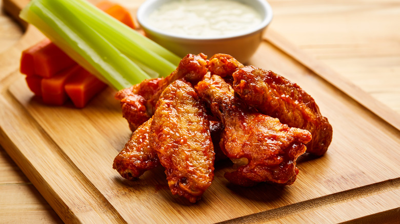 Buffalo wings sit on a cutting board