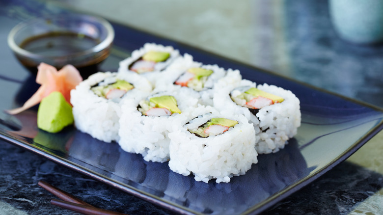 A California sushi roll sits on a plate