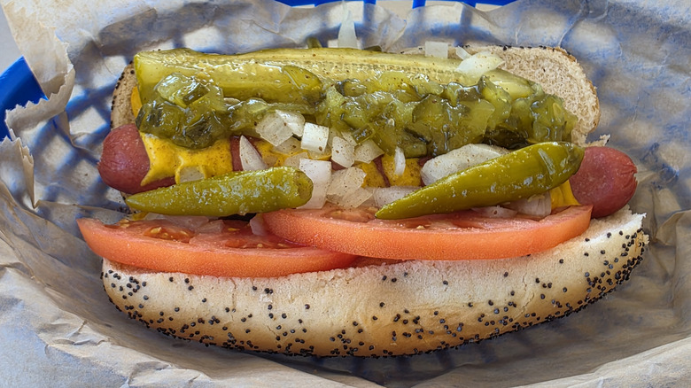 a Chicago-style hot dog in a blue plastic basket