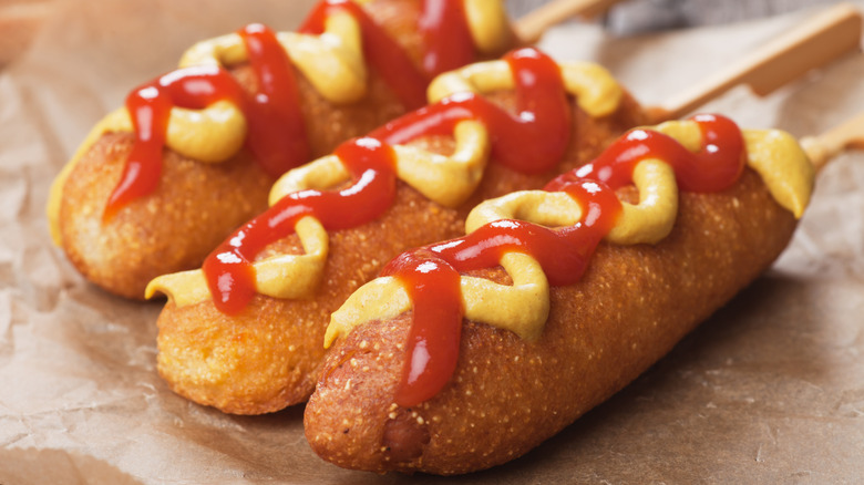Corn dogs with ketchup and mustard