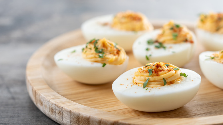 Deviled eggs on a wooden platter