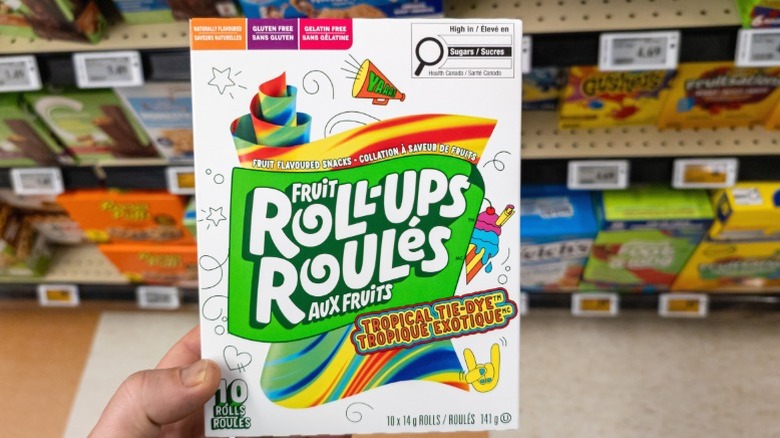 A box of Fruit Roll-Ups being held to the camera.