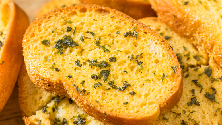 Close up of garlic bread on a pile of garlic bread