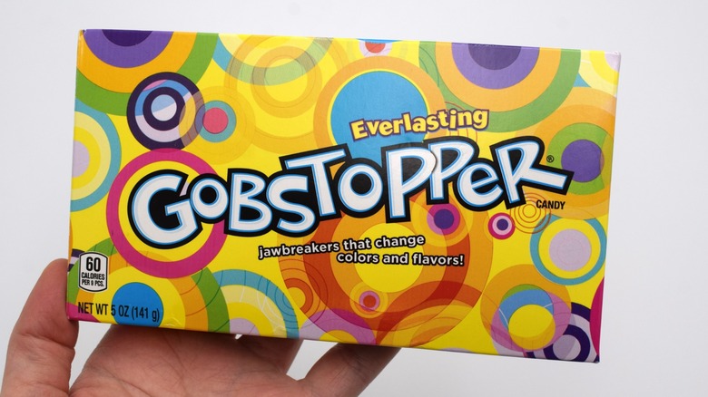 hand holds a box of gobstopper candy